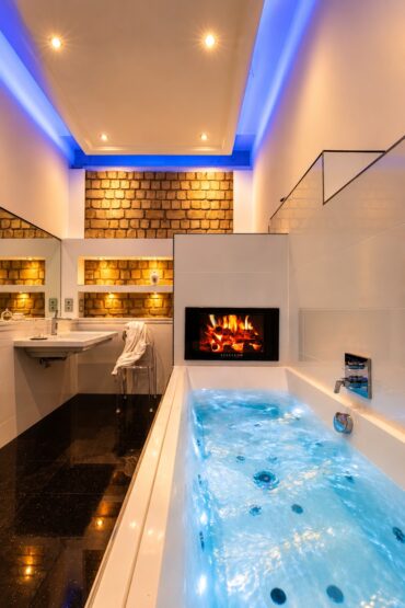 Private spa bathroom with bubbling whirlpool bath in the Grand Two-Bedroom Residence Heidelberg
