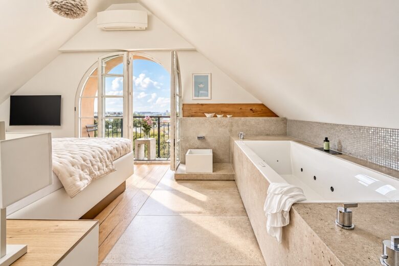 Bright bedroom with private whirlpool and French balcony in the Royal Three-Bedroom Penthouse Residence Heidelberg