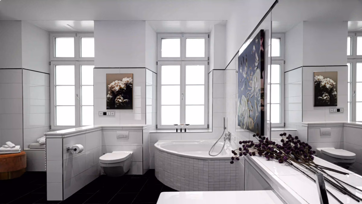 Elegant bathroom with corner bathtub and bright windows in the two-bedroom Superior Residence.