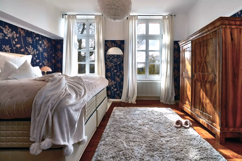 Cozy bedroom with king-size bed and vintage wardrobe in the two-bedroom Superior Residence.