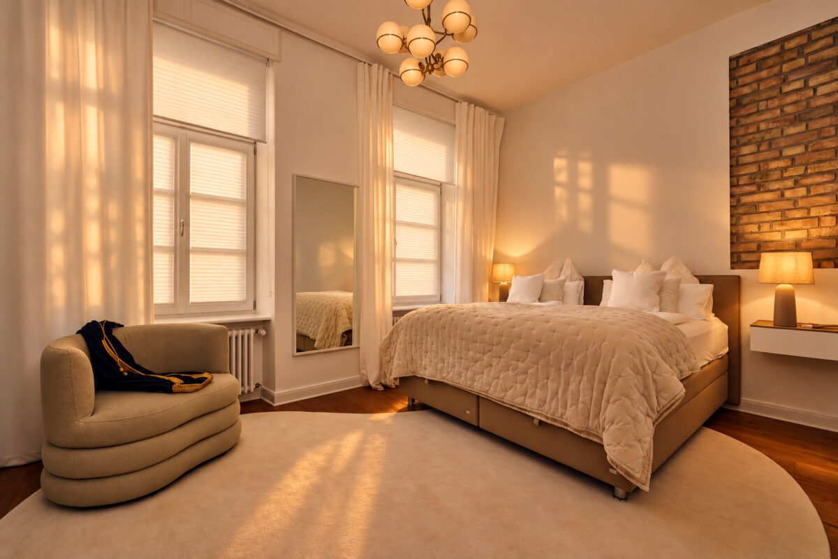 Private bedroom in the Signature Two-Bedroom Residence Heidelberg with warm evening light and closed pleated blinds