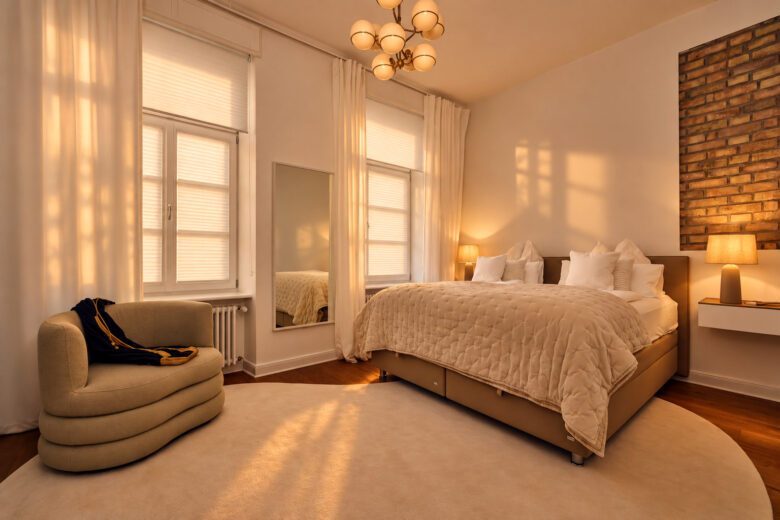 Private bedroom in the Signature Two-Bedroom Residence Heidelberg with warm evening light and closed pleated blinds