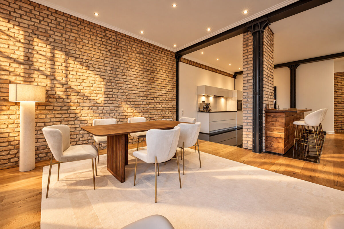 Dining area and private kitchen in the Signature Two-Bedroom Residence Heidelberg with warm evening light