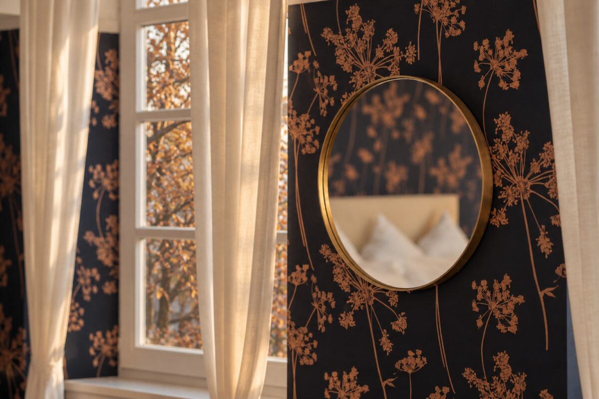 Bedroom detail with botanical wallpaper and autumn view in the Superior Two-Bedroom Residence Heidelberg