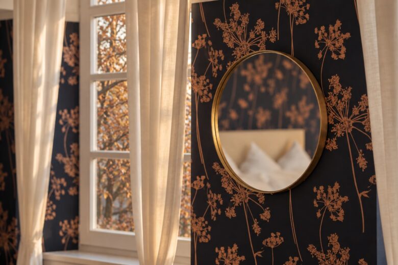 Bedroom detail with botanical wallpaper and autumn view in the Superior Two-Bedroom Residence Heidelberg
