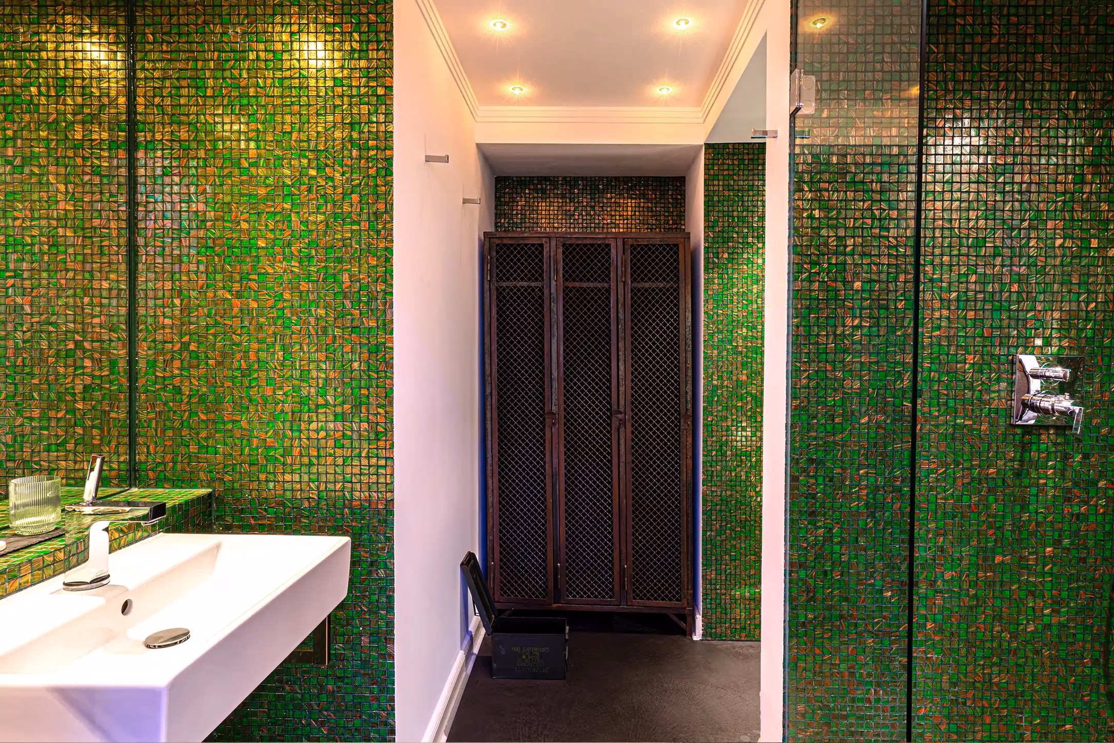 Design bathroom with green mosaic tiles and rain shower