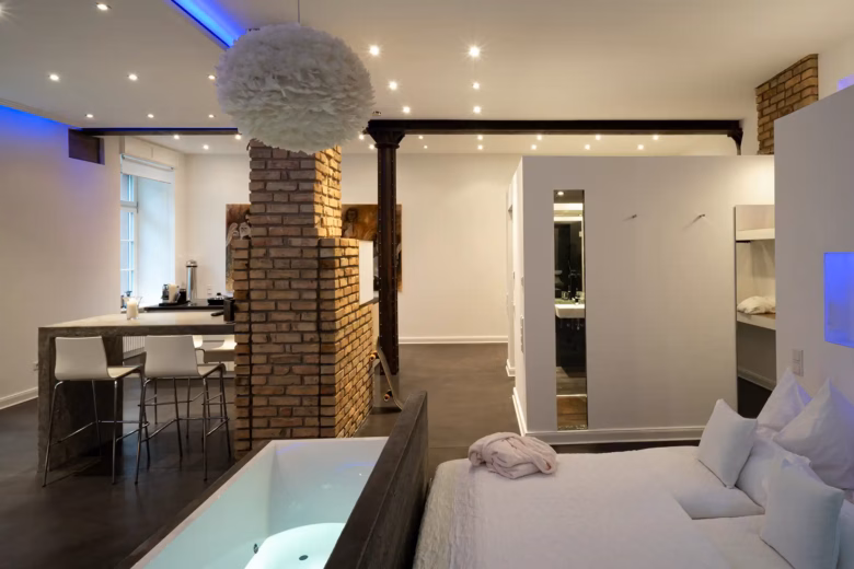 Spacious loft with open-plan design, brick wall and modern interior