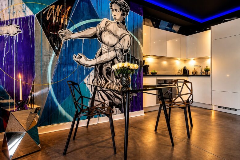 Dining area in the Executive Design Loft Heidelberg with modern kitchen and statement mural