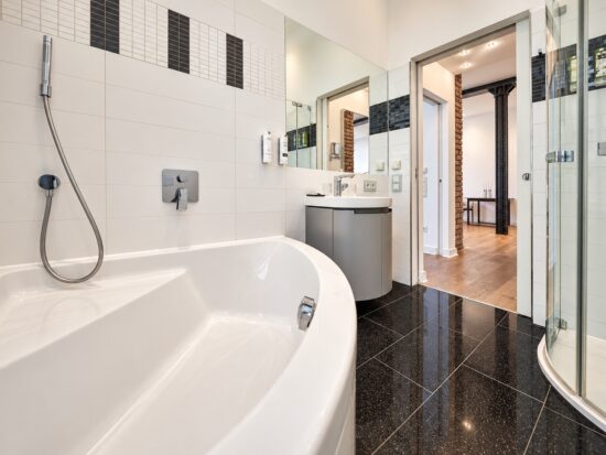 Private bathroom with bathtub and walk-in shower in the Executive One-Bedroom Residence Heidelberg