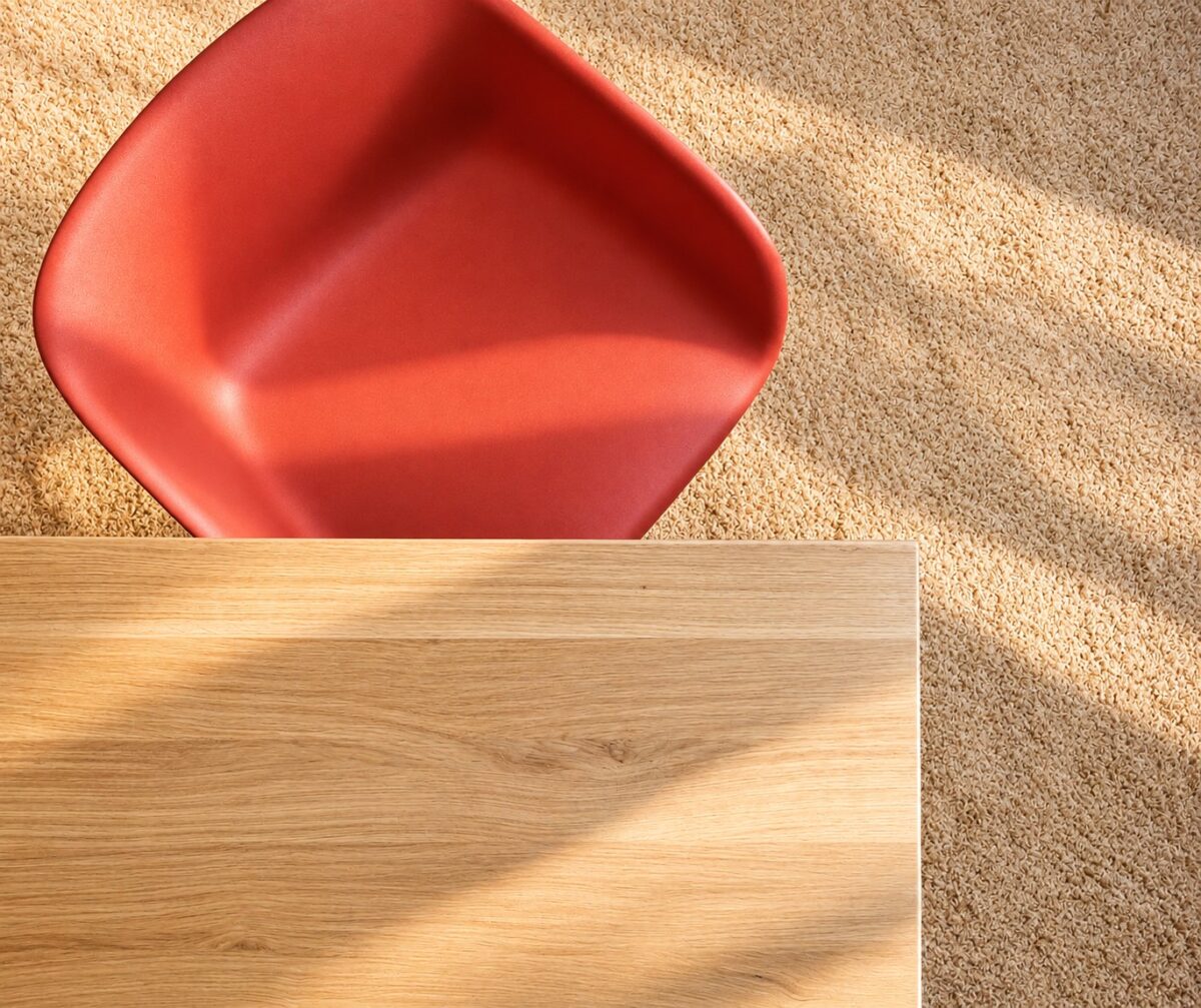 Dining area design detail with oak table and coral chair in the Two-Bedroom Companion Apartment Heidelberg