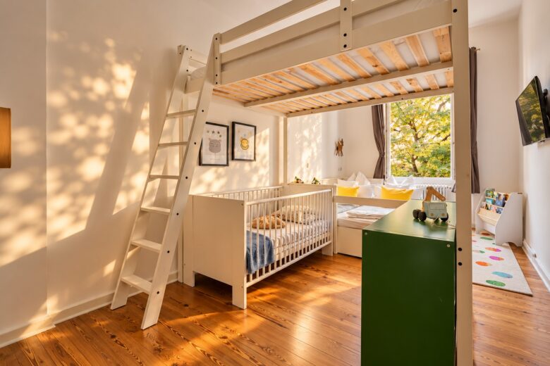 Bright children’s room with loft bed, crib, and play area – ideal for long-term family stays in Heidelberg