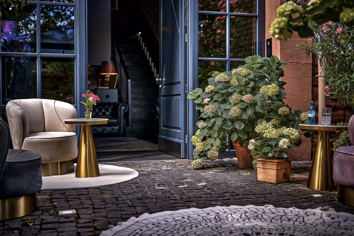 Private hotel entrance with elegant lounge seating and flowers at Boutique Suites and Residences Heidelberg.