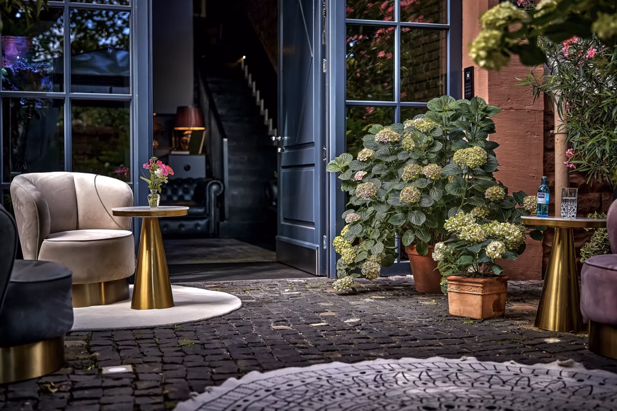 Private hotel entrance with elegant lounge seating and flowers at Boutique Suites and Residences Heidelberg.