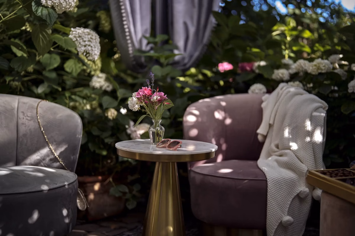 Private garden seating with flowers, soft chairs, and afternoon light at Boutique Suites and Residences Heidelberg.