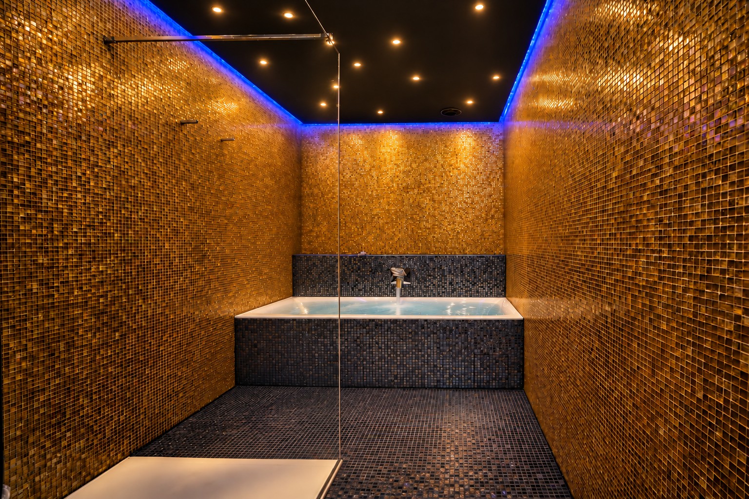 Private whirlpool surrounded by shimmering gold mosaics in the One-Bedroom Residential Suite Heidelberg