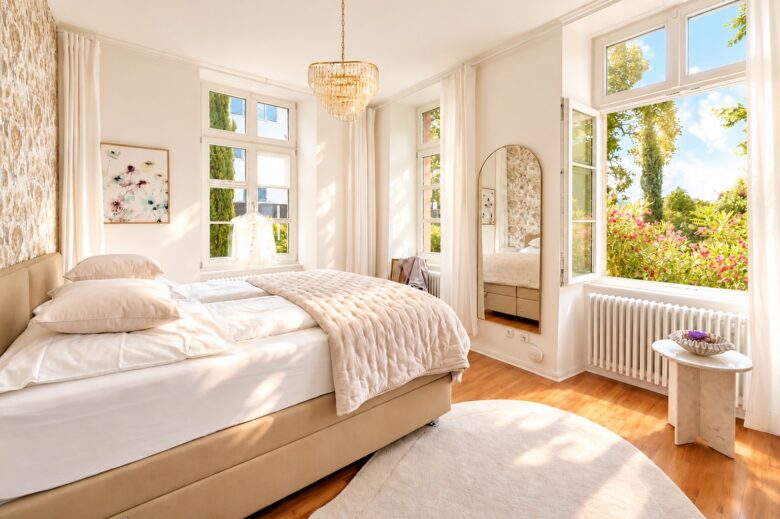 Private bedroom in the Imperial Two-Bedroom Suite Heidelberg with garden view and soft spring morning light