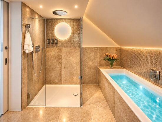 Private spa bathroom in the Royal Three-Bedroom Penthouse Residence Heidelberg with illuminated whirlpool, walk-in shower and warm ambient lighting