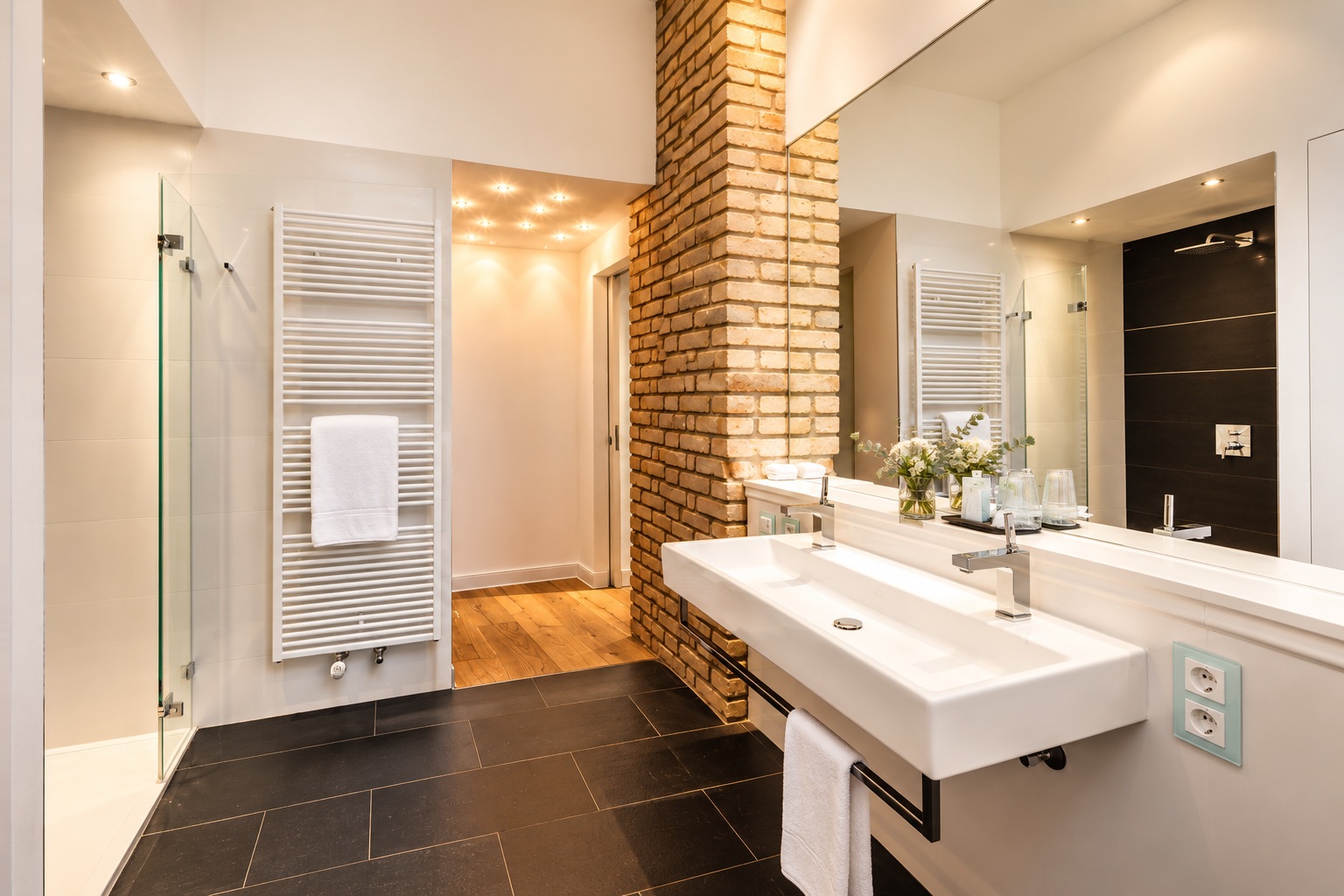 Bright bathroom in the Signature Two-Bedroom Residence Heidelberg with double vanity, glass shower, exposed brick and elegant residential styling