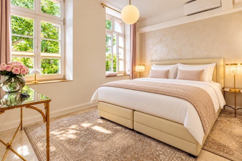 Elegant principal bedroom in the Signature Two-Bedroom Suite Heidelberg with professionally prepared king-size bed, soft natural light and refined residential design