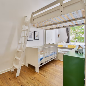 Bright children’s room with loft bed, crib, and play area – ideal for long-term family stays in Heidelberg