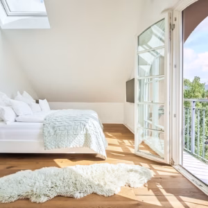 Penthouse Royal master bedroom at Boutique Suites and Residences Heidelberg with king-size bed, balcony, and panoramic city views
