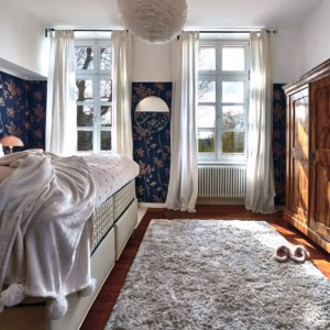 Cozy bedroom with king-size bed and vintage wardrobe in the two-bedroom Superior Residence.