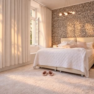 King-size bed in the Business Studio Residence Heidelberg in soft early morning light