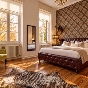 Private master bedroom with king bed in the Deluxe Two-Bedroom Serviced Apartment Heidelberg