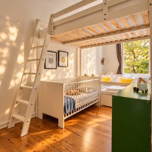 Children's bedroom with loft bed and crib in the Family Apartment Heidelberg