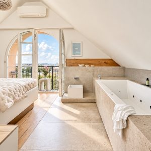 Bright bedroom with private whirlpool and French balcony in the Royal Three-Bedroom Penthouse Residence Heidelberg