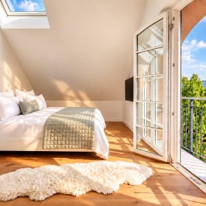 Penthouse Royal master bedroom at Boutique Suites and Residences Heidelberg with king-size bed, balcony, and panoramic city views