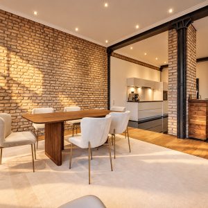 Dining area and private kitchen in the Signature Two-Bedroom Residence Heidelberg with warm evening light